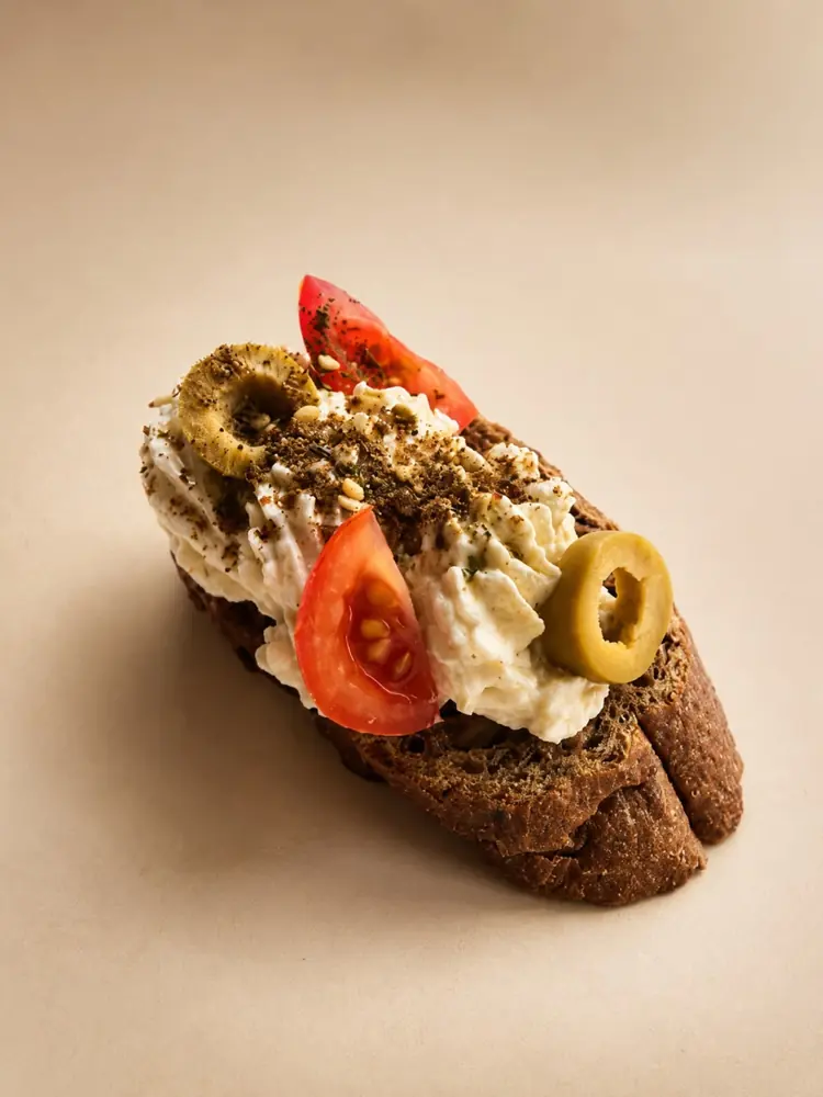 Bruschetta with whipped cheese, tomato and olives