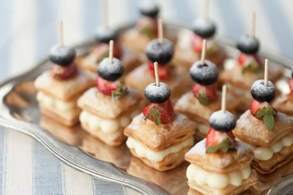 Mini puff pastry bites with cream and blueberries