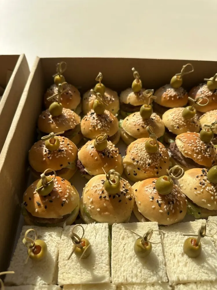 Box of mini sliders and sandwiches with olives